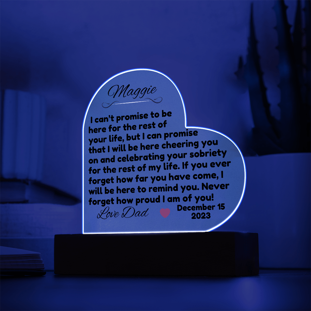 Acrylic LED heart sign with Maggie message, white glow outline on black wooden base