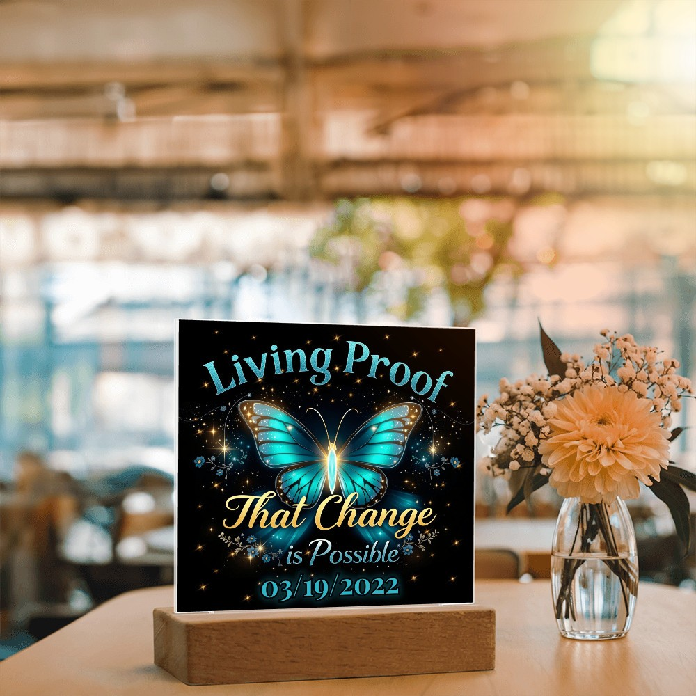 LED acrylic plaque with teal butterfly glow and 'Living Proof That Change is Possible 03/19/2022' on base