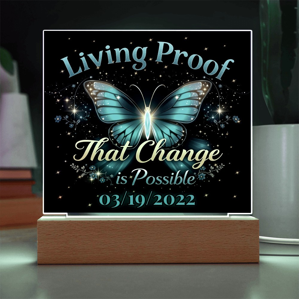 LED acrylic plaque with blue butterfly glow and 'Living Proof That Change is Possible 03/19/2022'