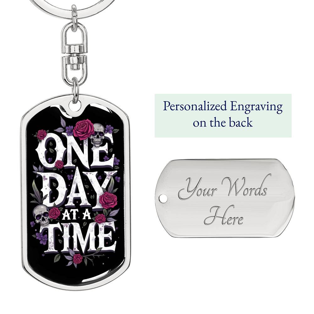 Silver dog tag keychain with front “One Day At A Time” design and back engraving area
