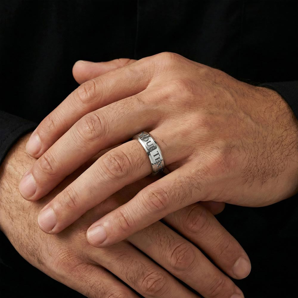 Silver engraved date ring on hand, close view of band lettering