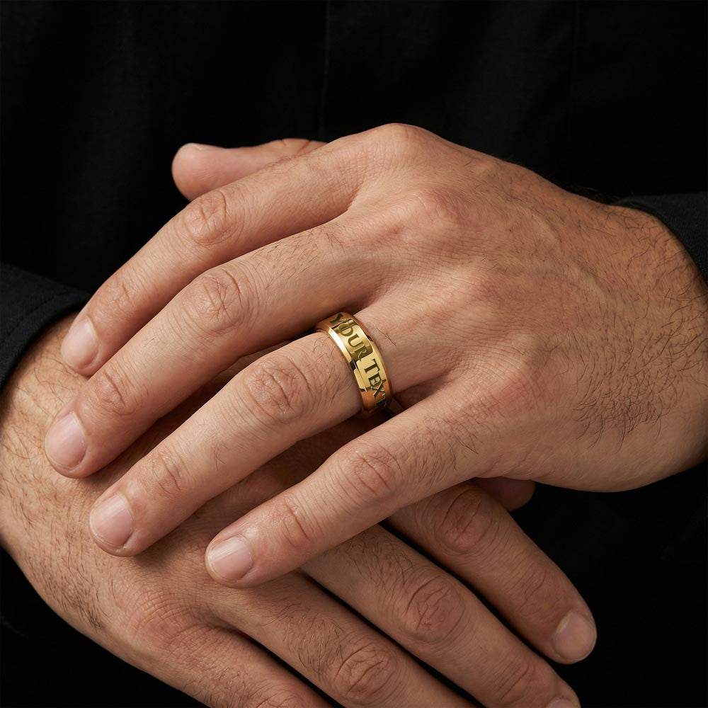 Gold engraved date ring on hand, close view of band lettering