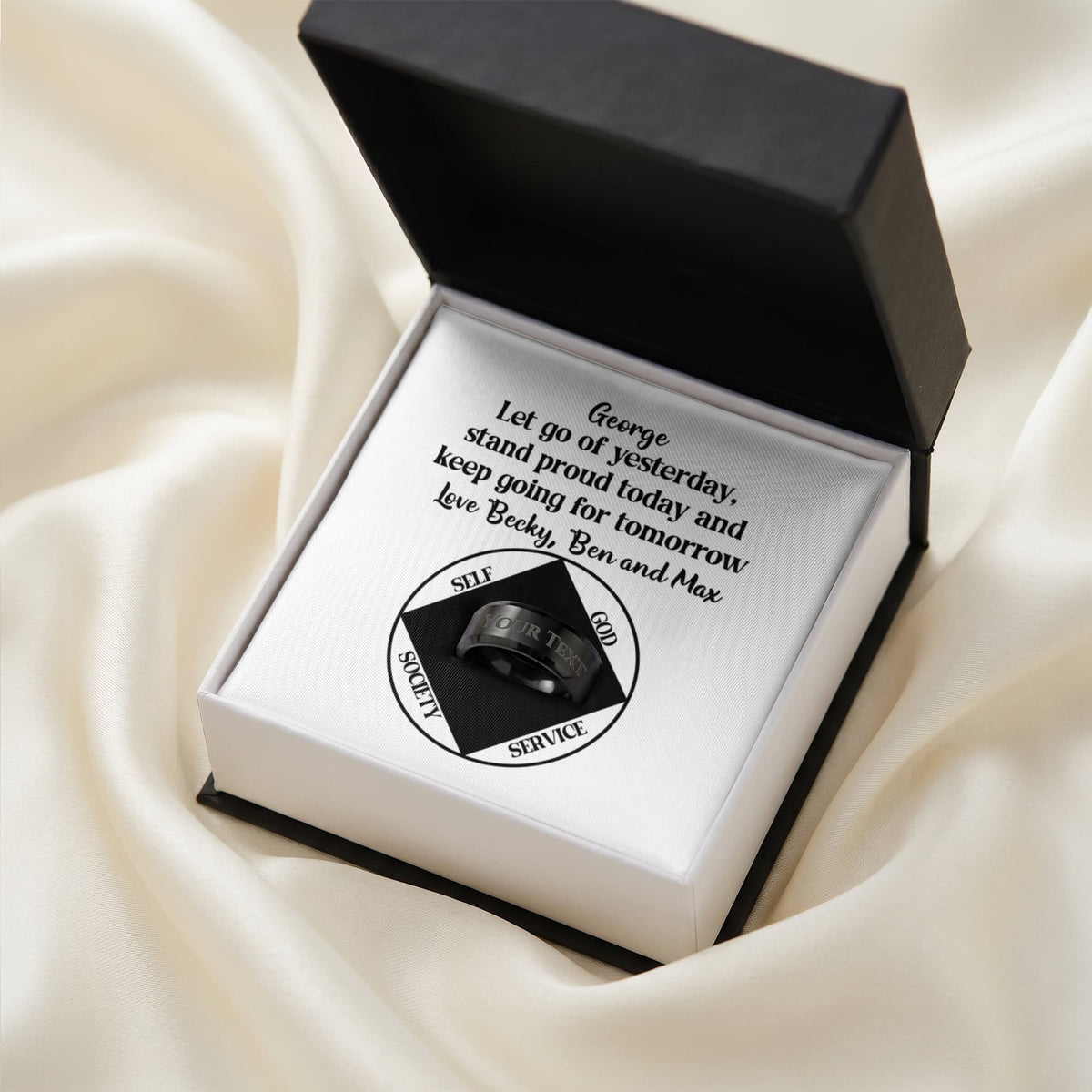 Open gift box with personalized clean-date message card and circular emblem
