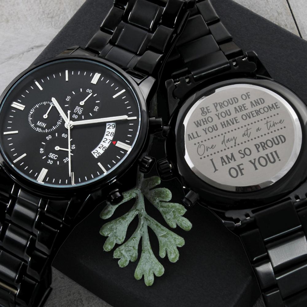 Men's watch with black metal bracelet, black dial, and engraved gift disc