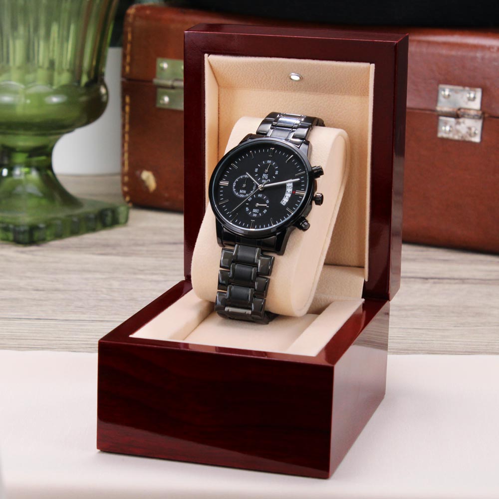 Men's black chronograph wrist watch in a red gift box with beige insert