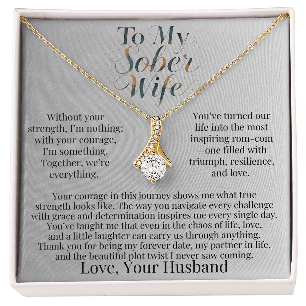 Gold-tone teardrop pendant necklace with faceted stone on a chain