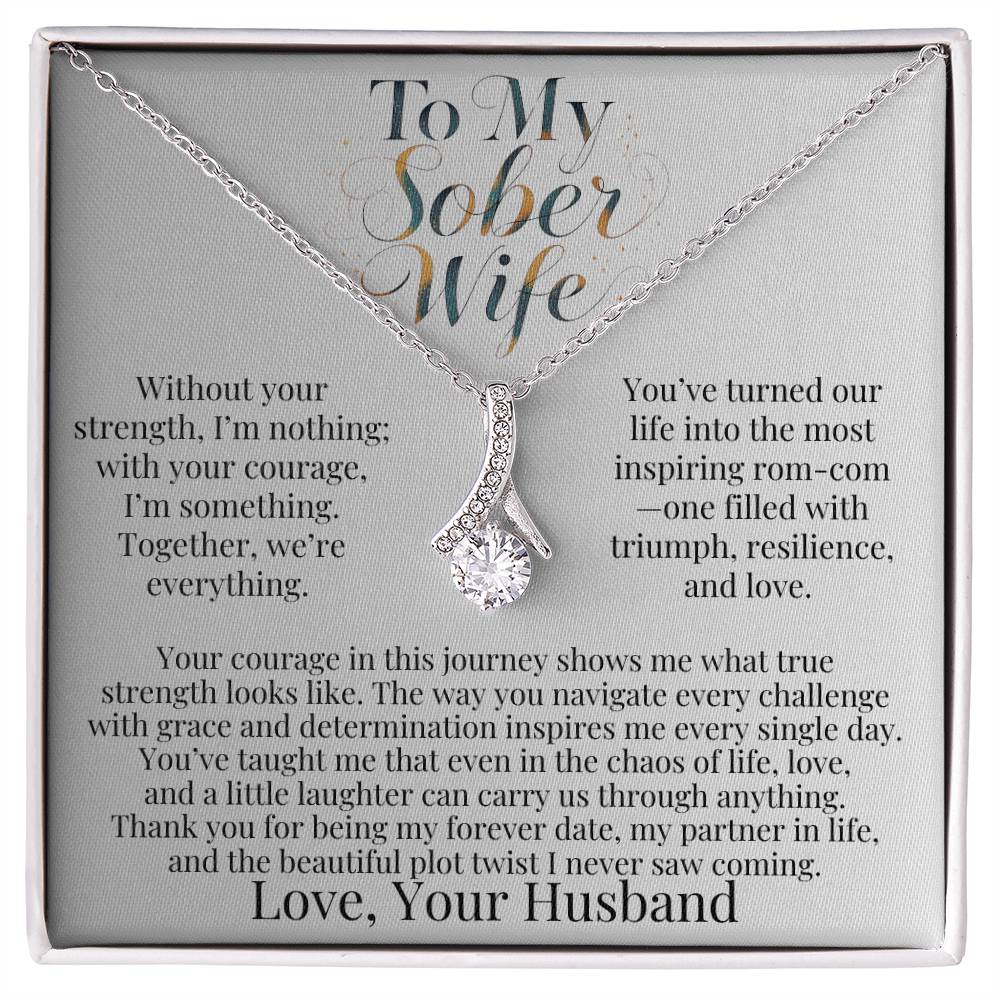 Silver-tone teardrop pendant necklace with faceted stone on a chain