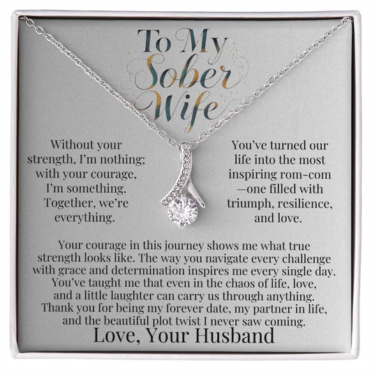 Silver-tone teardrop pendant necklace with faceted stone on a chain