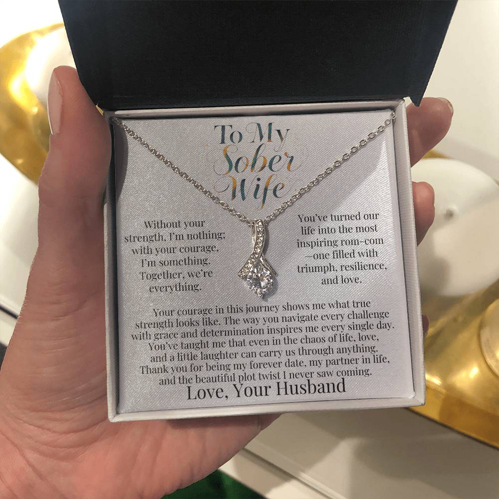 Silver-tone teardrop pendant necklace in gift box held in hand
