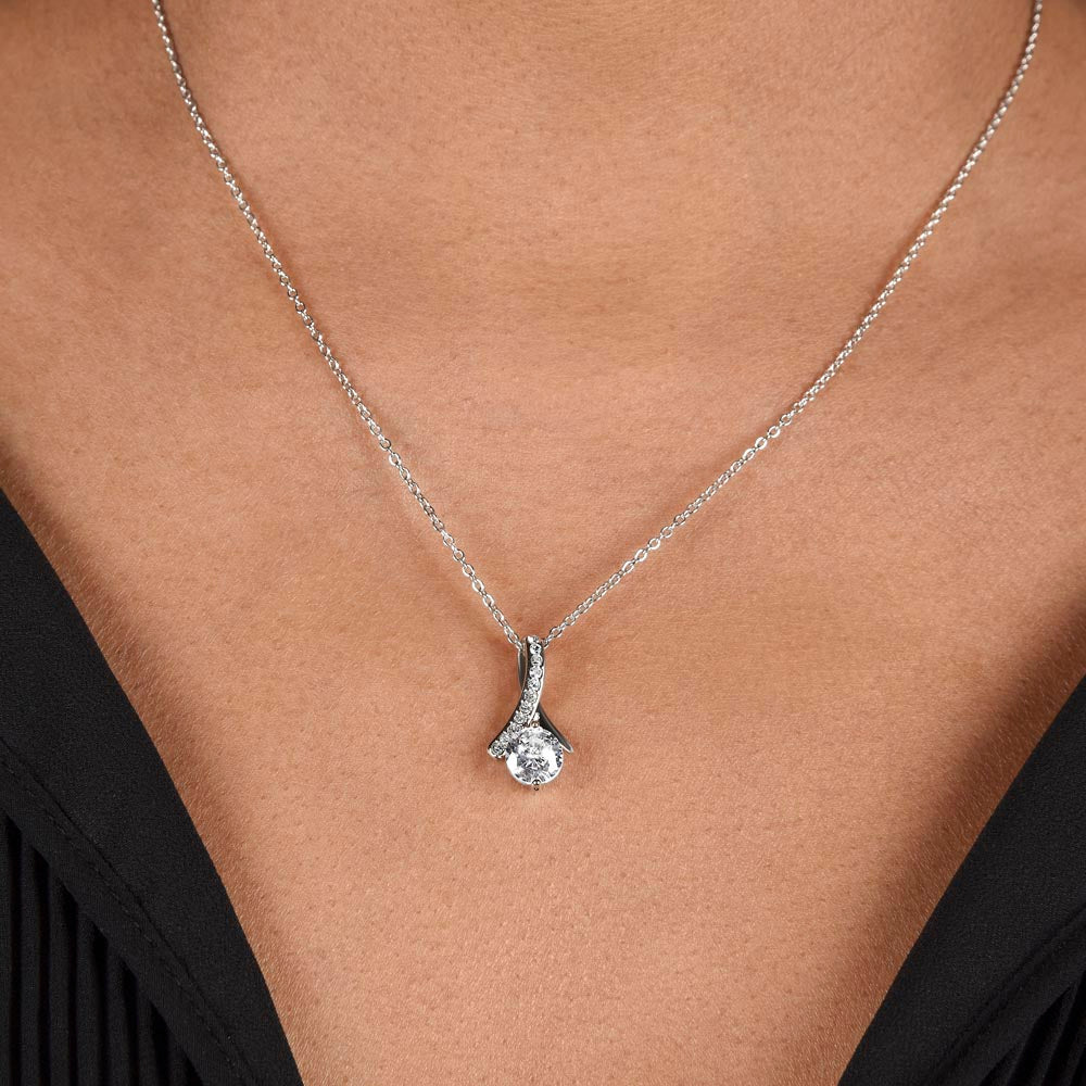 Silver-tone teardrop pendant necklace with clear stones on a fine chain