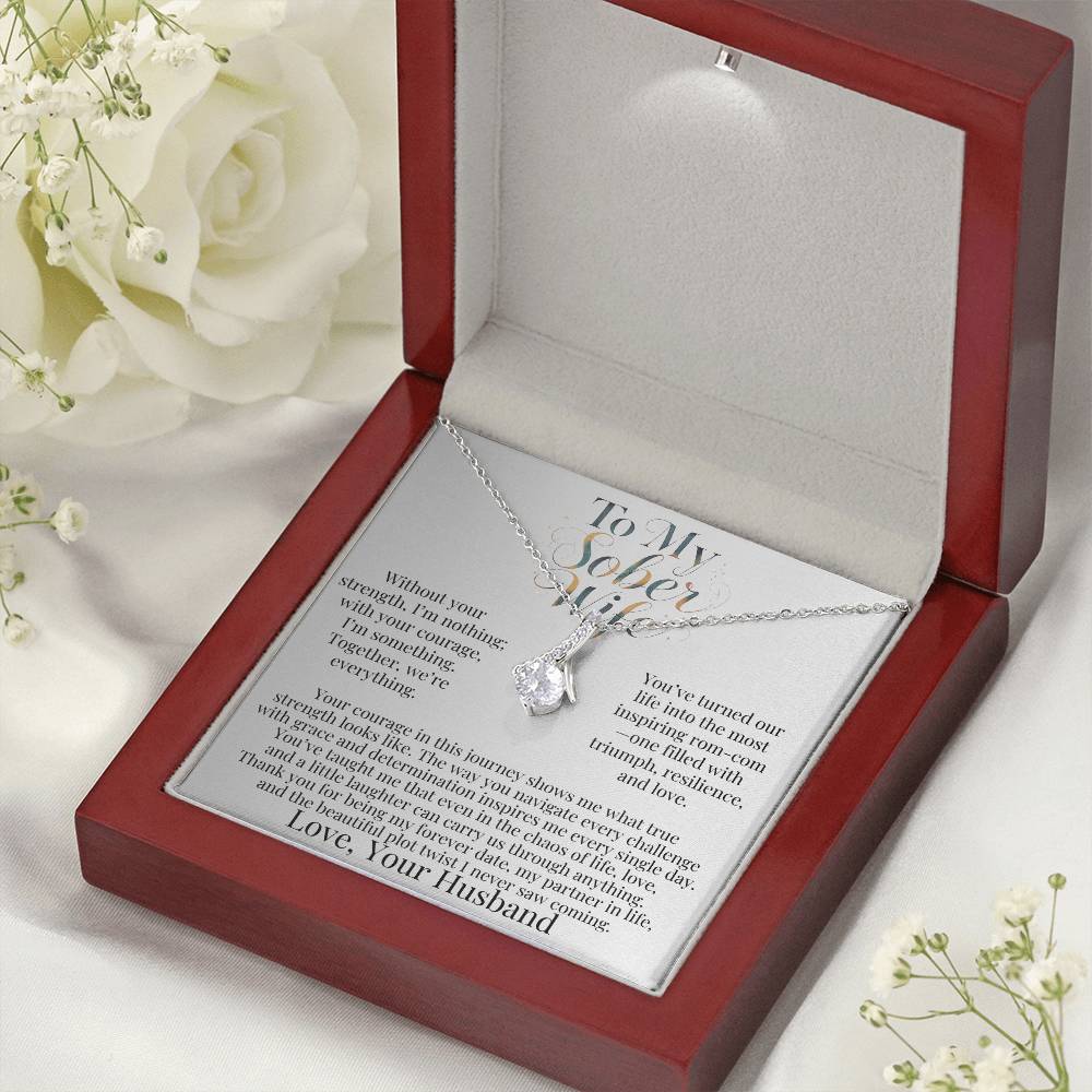 Silver-tone teardrop pendant necklace inside red gift box