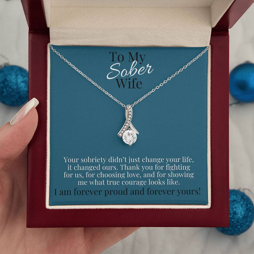 Silver-tone teardrop pendant necklace in red gift box with blue card backing