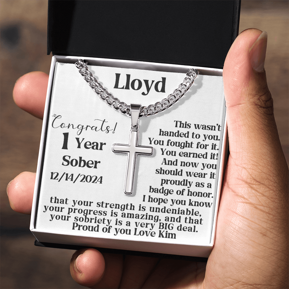 Close-up of silver chain necklace with cross pendant in a gift box