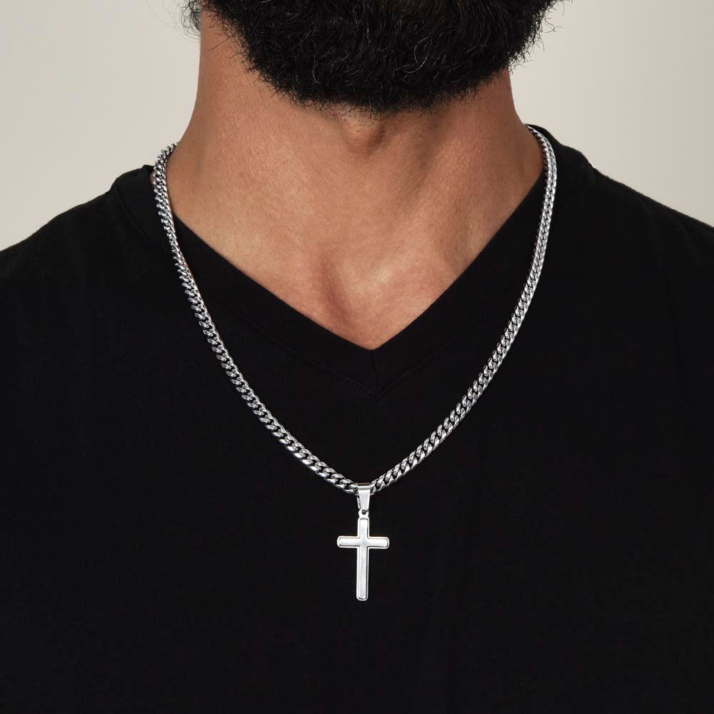 Silver-tone cross pendant necklace worn on a black V-neck shirt