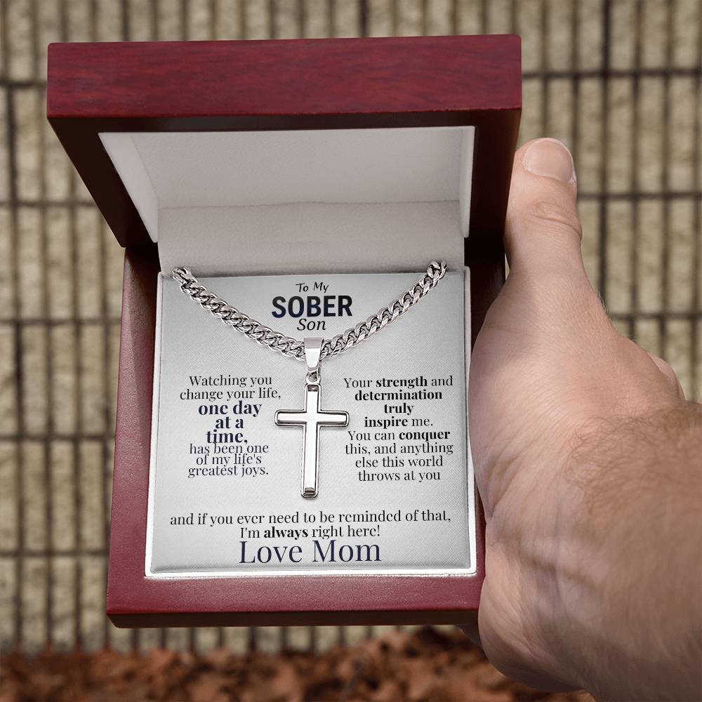 Cross necklace and message card in red gift box held in hand
