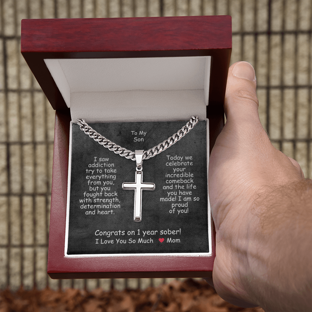 Cross pendant necklace in a red gift box, open packaging.