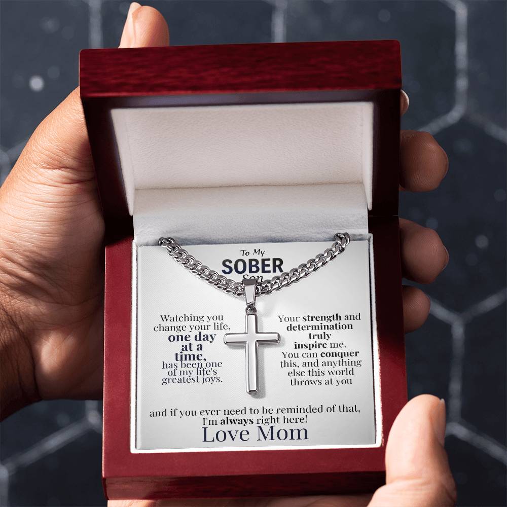 Cross necklace in red gift box with message card, held up