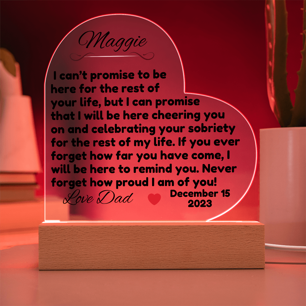 Acrylic LED heart sign with Maggie message, red glow outline on wooden base