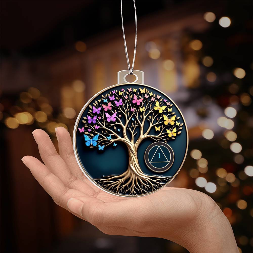 Tree of Life sobriety ornament held in hand, round disc with butterflies, tree, and AA symbol