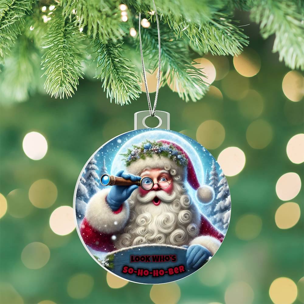 Round Santa ornament hanging from a green pine branch, blue telescope and “So-Ho-Ho-Ber”