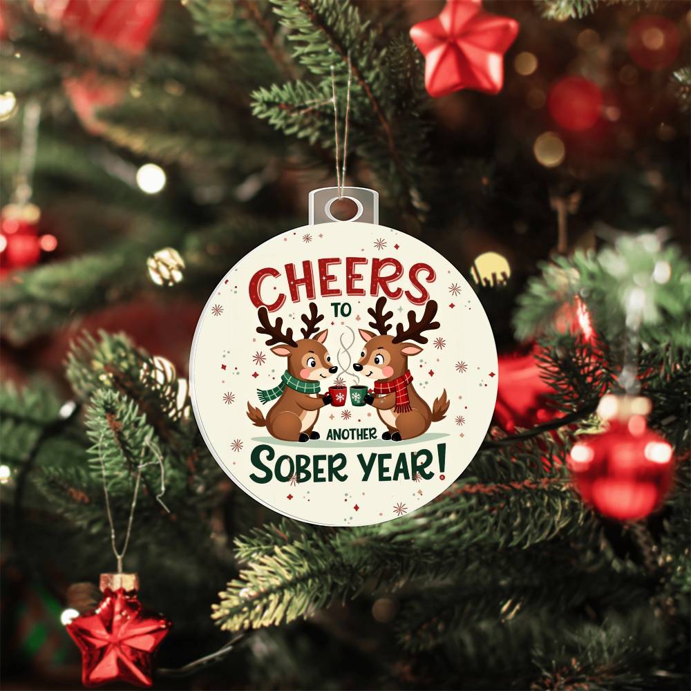 Round Christmas ornament on a tree: 'Cheers to Another Sober Year!' with reindeer