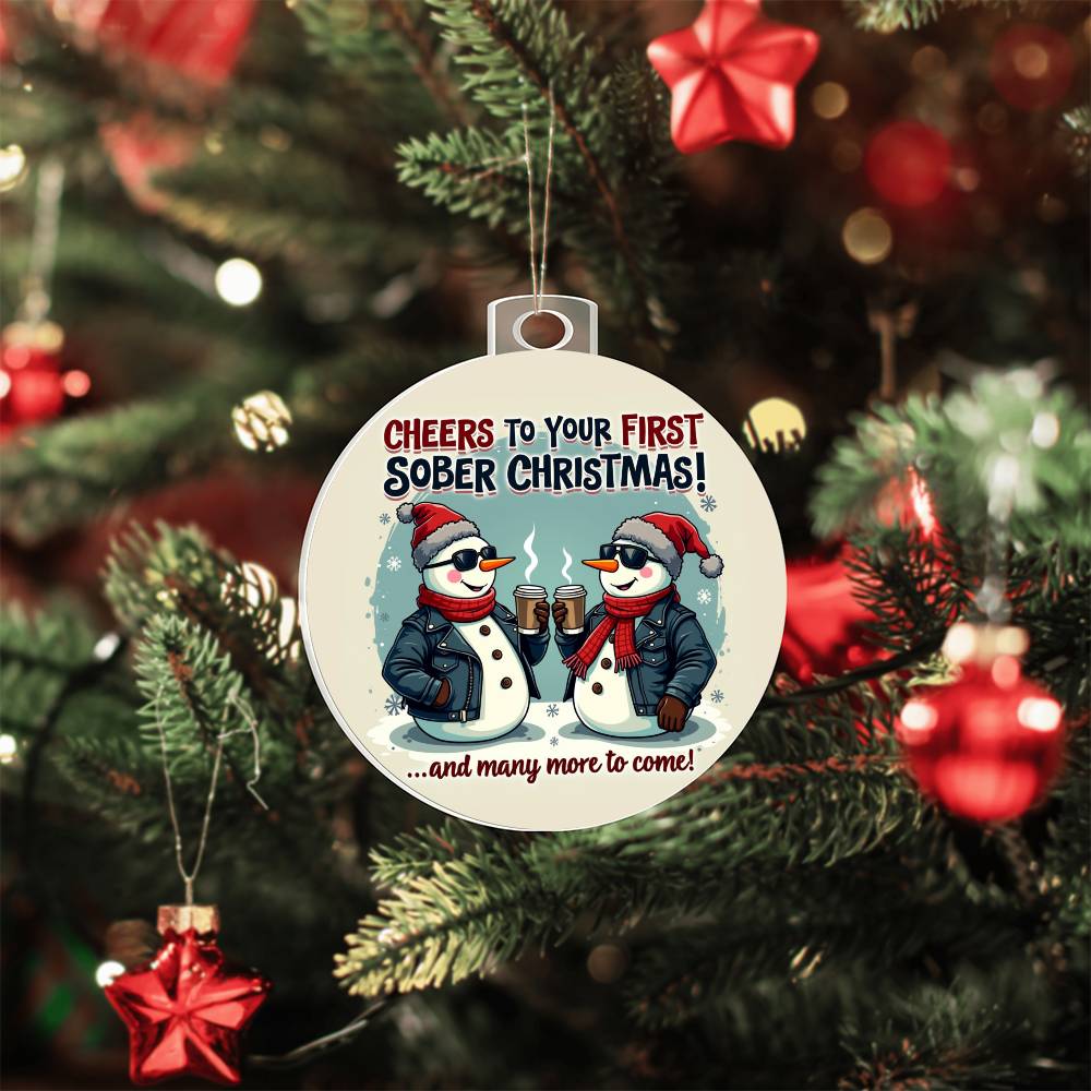 Round Christmas ornament with penguin graphic, hanging loop, blue and red accents