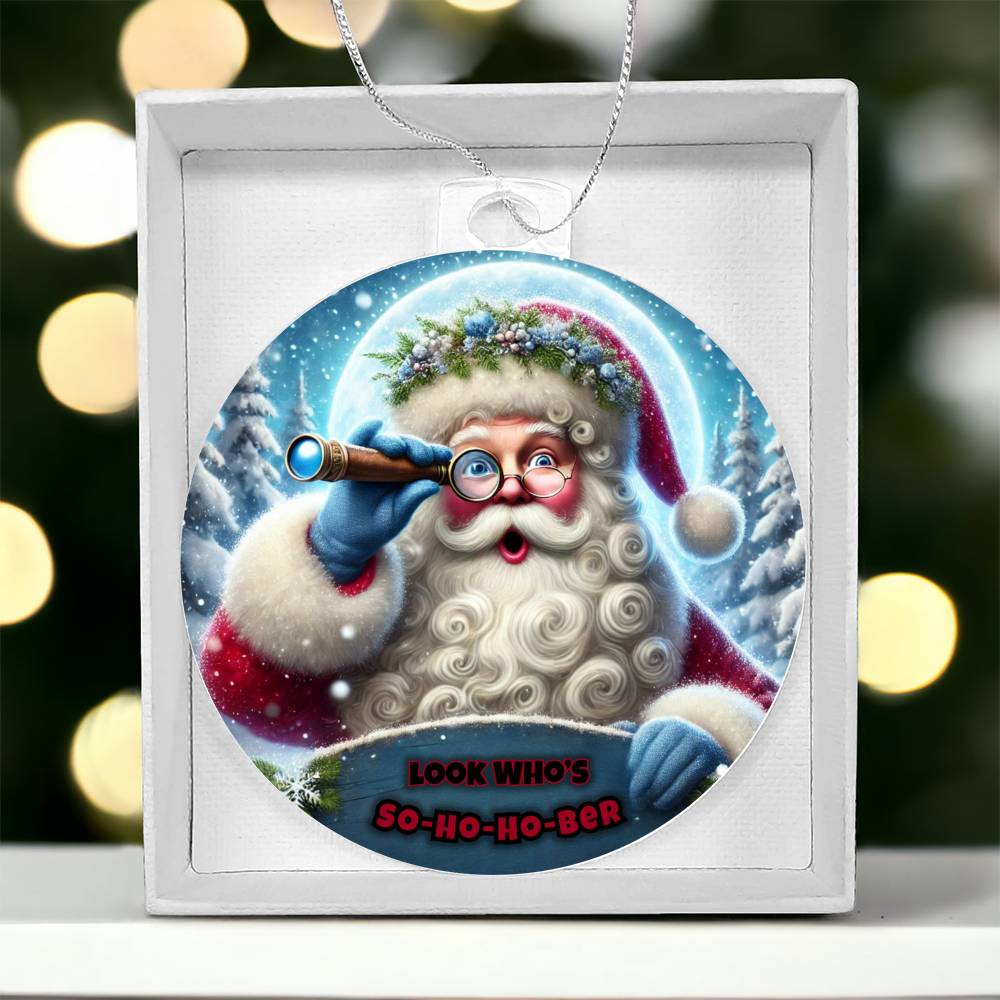 Round Santa ornament inside white gift box, blue telescope and “So-Ho-Ho-Ber” text