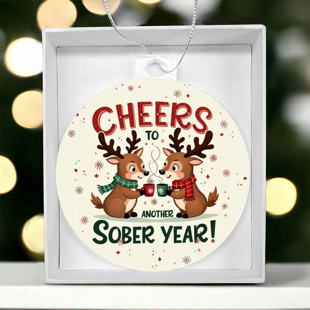 Round ornament in a gift box: 'Cheers to Another Sober Year!' with reindeer mugs