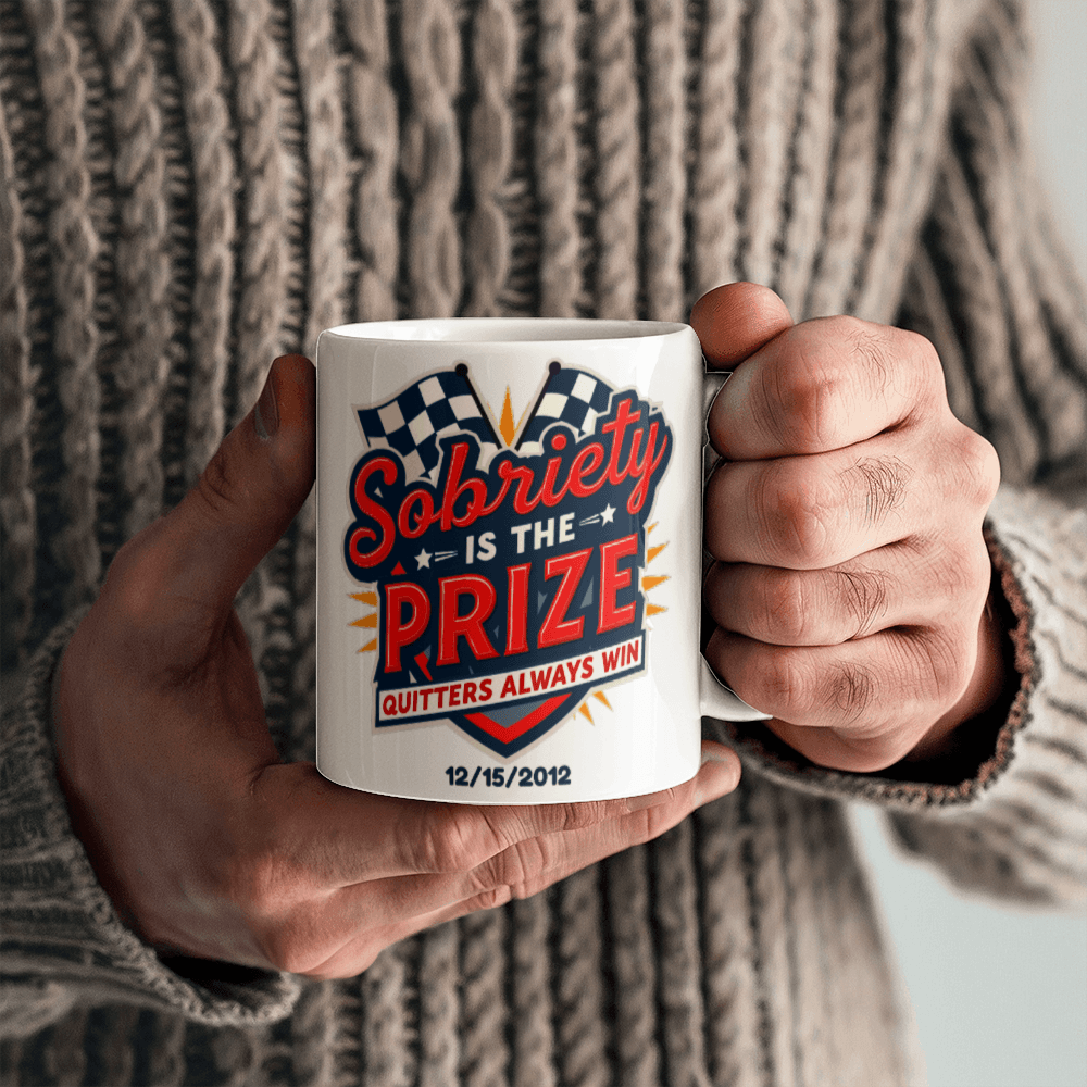 Customizable white mug in a fist grip featuring “Sobriety is the Prize” and “Quitters always win”