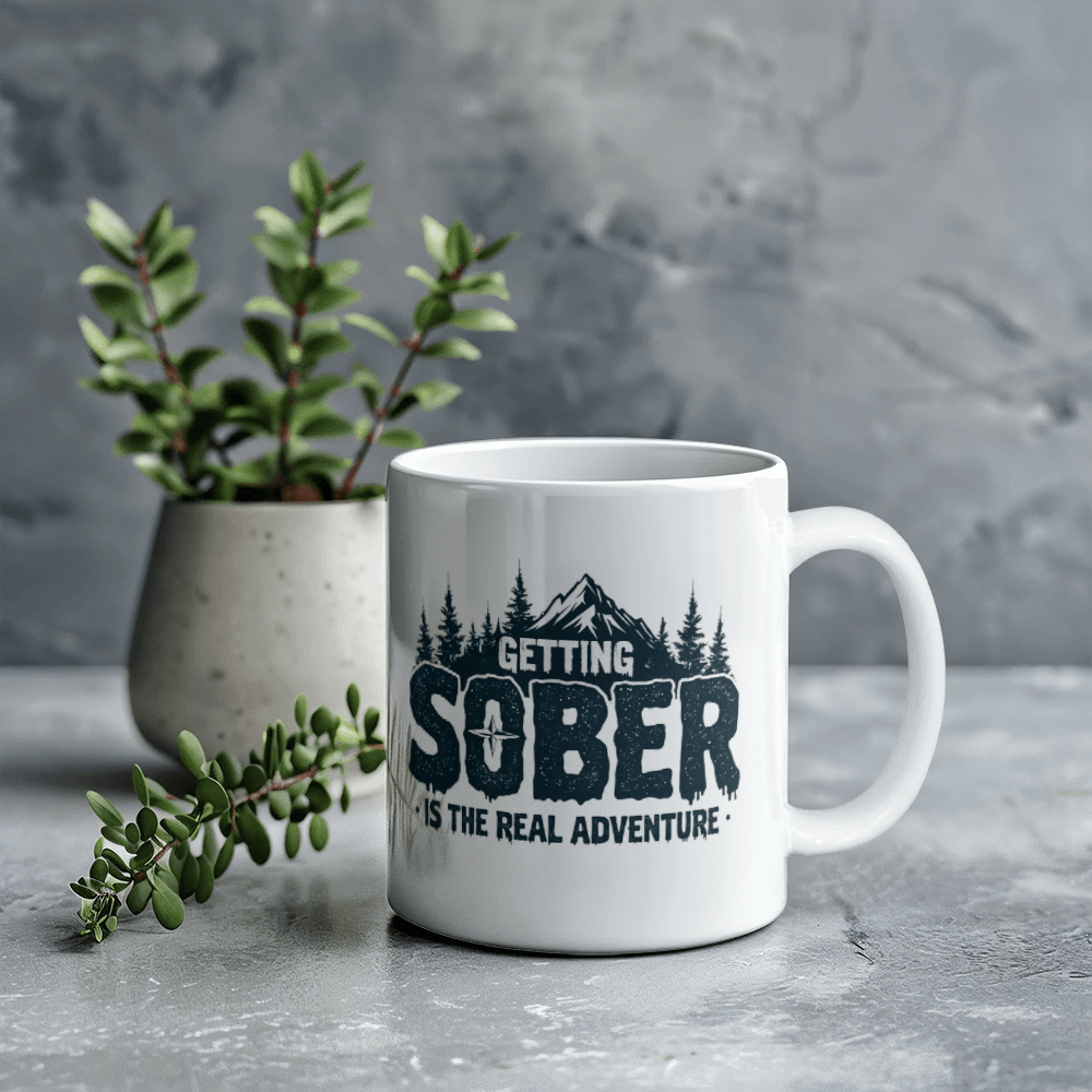 White ceramic mug with black 'GETTING SOBER' print and pine tree graphic