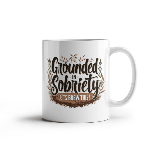 White coffee mug with “Grounded in Sobriety” and “Let’s Brew This!” print on front