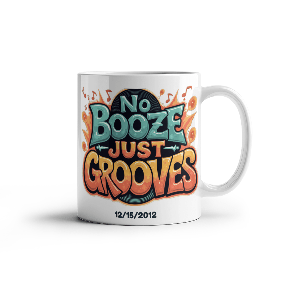 White ceramic mug isolated on white with 'No Booze Just Grooves' print and date 12/15/2012