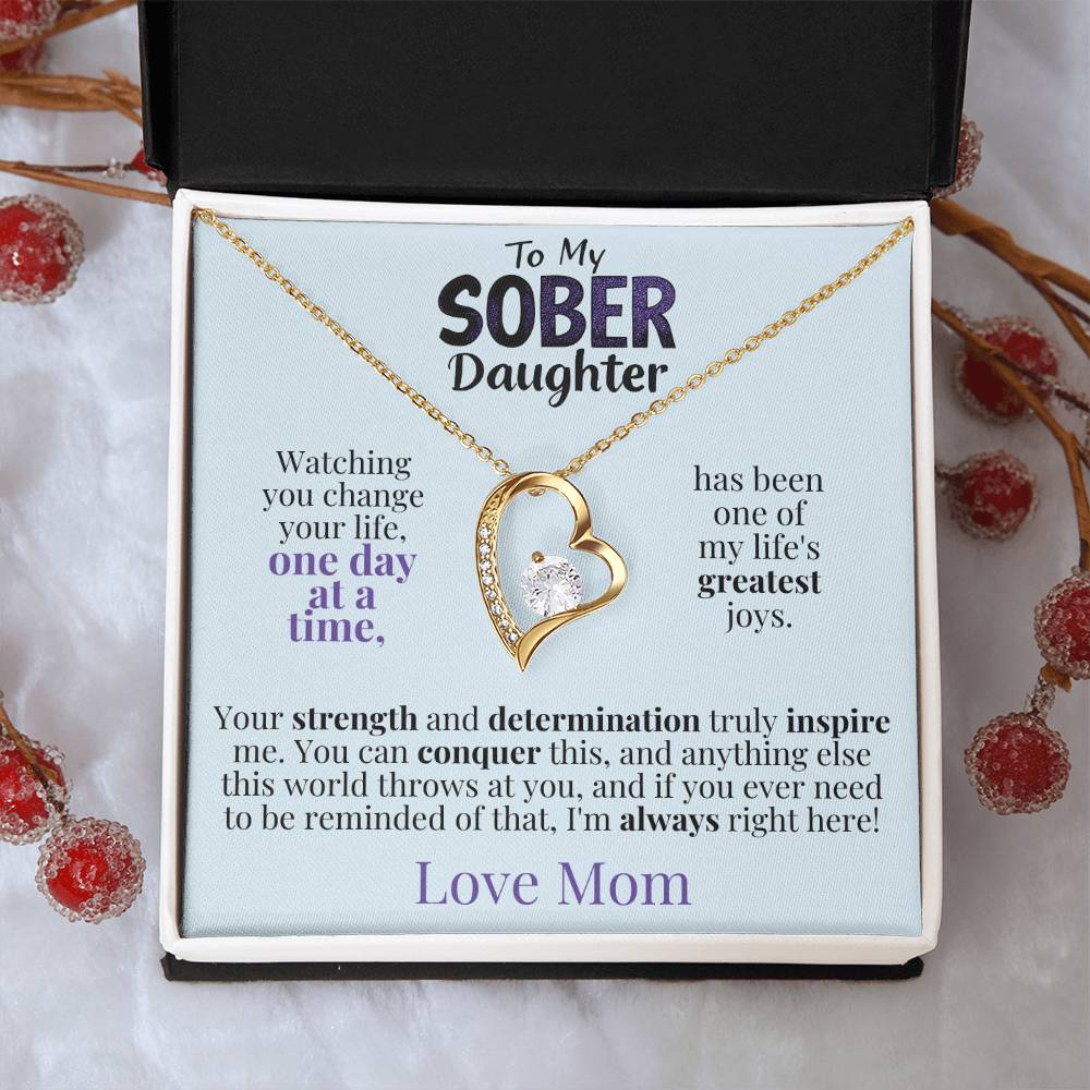 Gold heart pendant necklace with a printed message card in a gift box