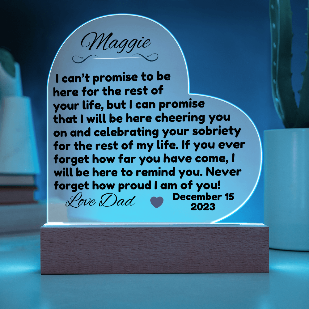 Acrylic LED heart sign with Maggie message, blue glow outline on dark wooden base