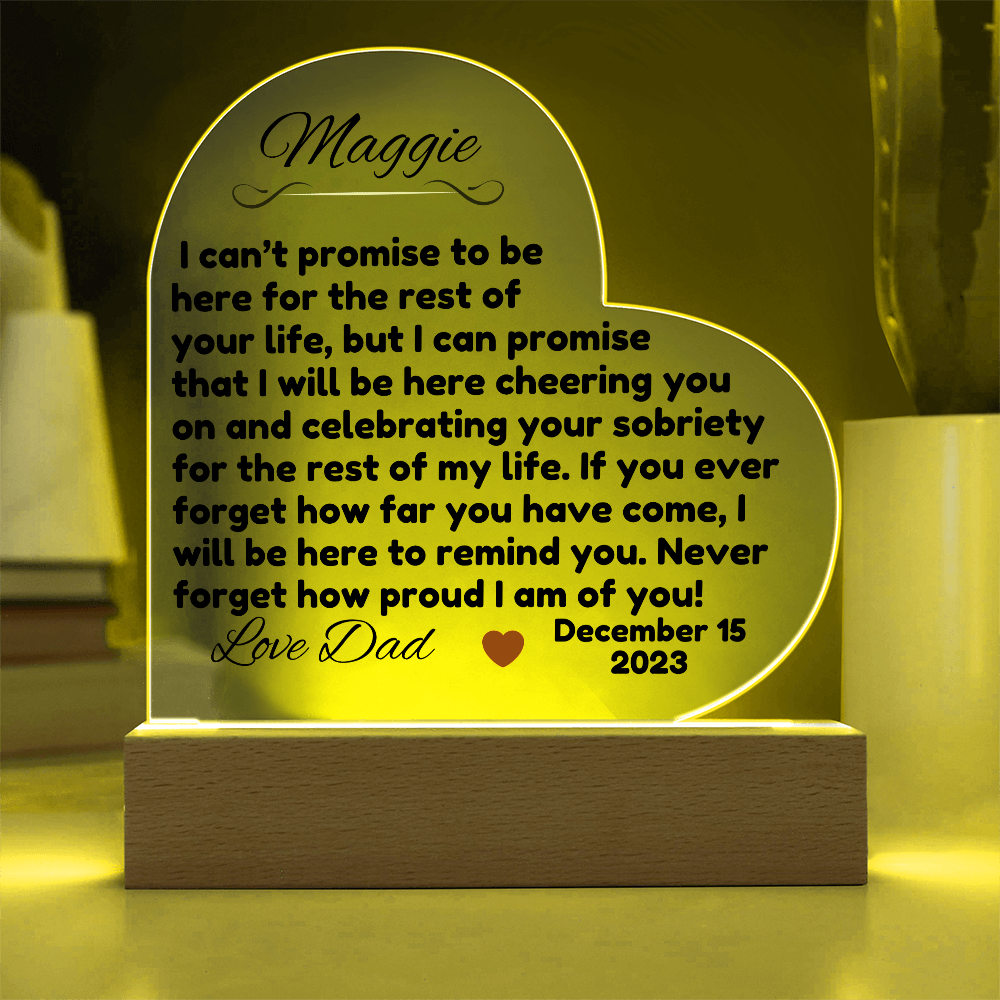 Acrylic LED heart sign with Maggie message, yellow glow outline on wooden base