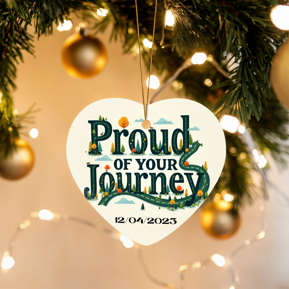 Heart ornament with “Proud of your Journey” and “12/04/2023”, suspended on gold cord.