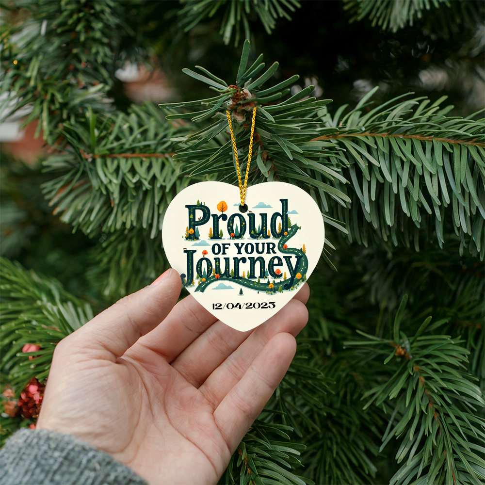 Heart ornament with “Proud of your Journey” and “12/04/2025”, on a gold hanging cord.