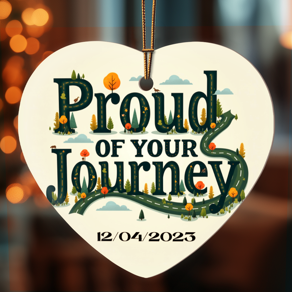 Heart ornament with “Proud of your Journey” and “12/04/2023” with gold cord hanger.