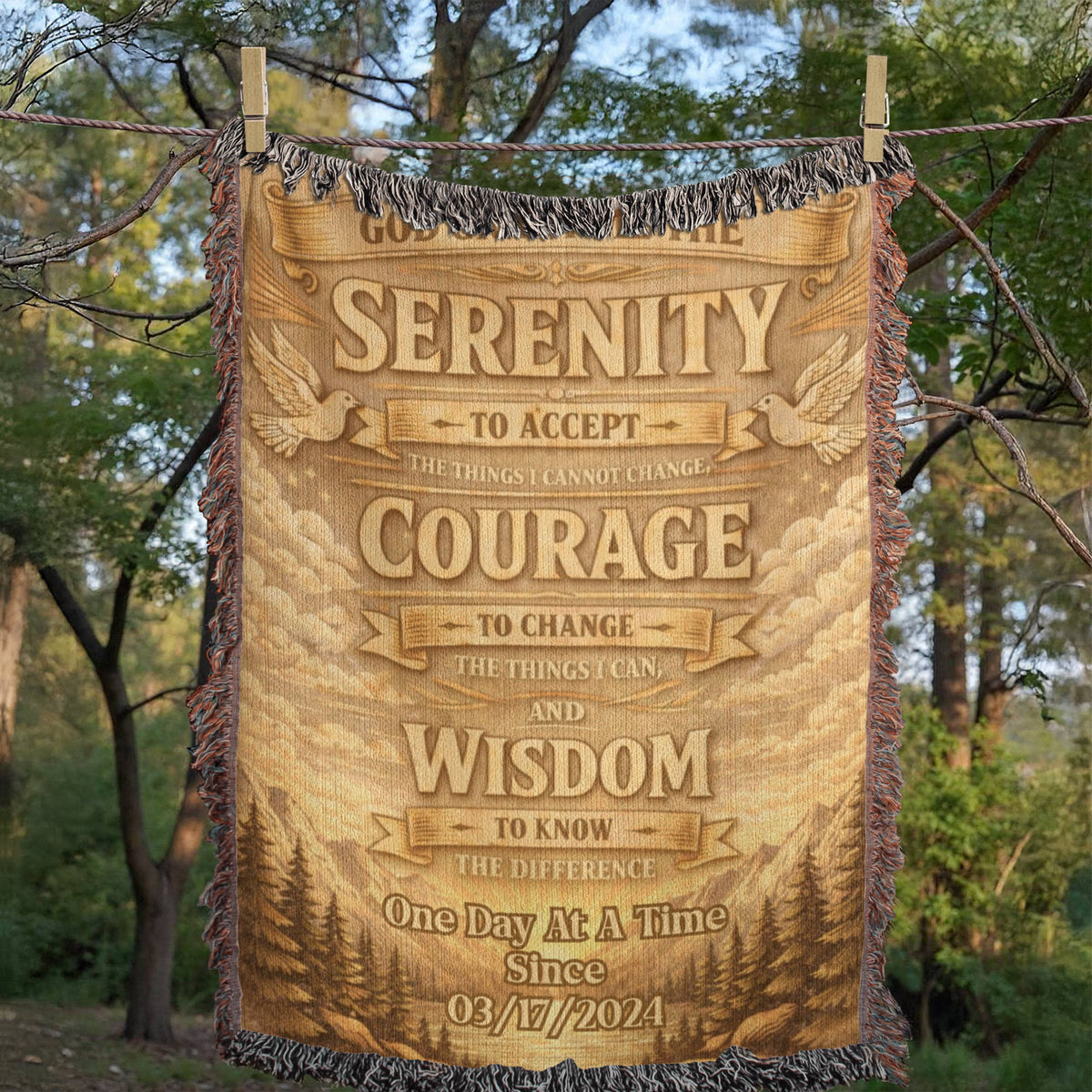 Beige woven blanket hanging outdoors with fringe trim and prayer verse text