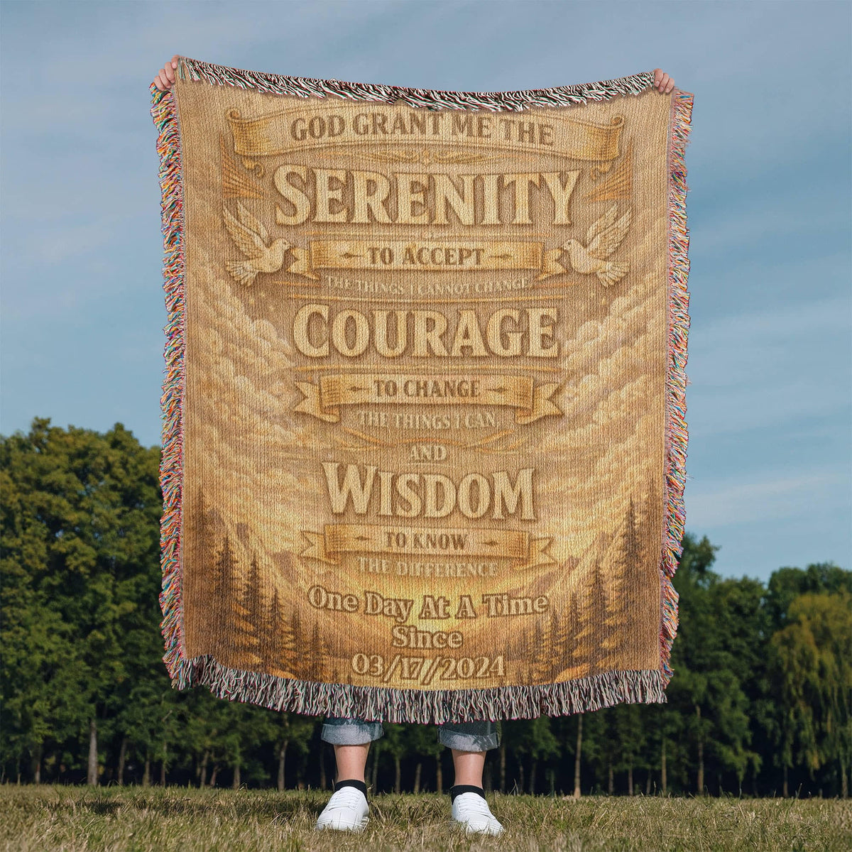 Tan woven blanket featuring Serenity prayer wording and tassel fringe along the edges