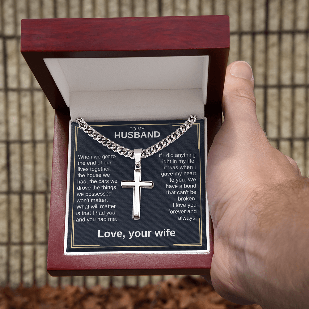 Cross pendant necklace in hand, silver curb chain with cross charm