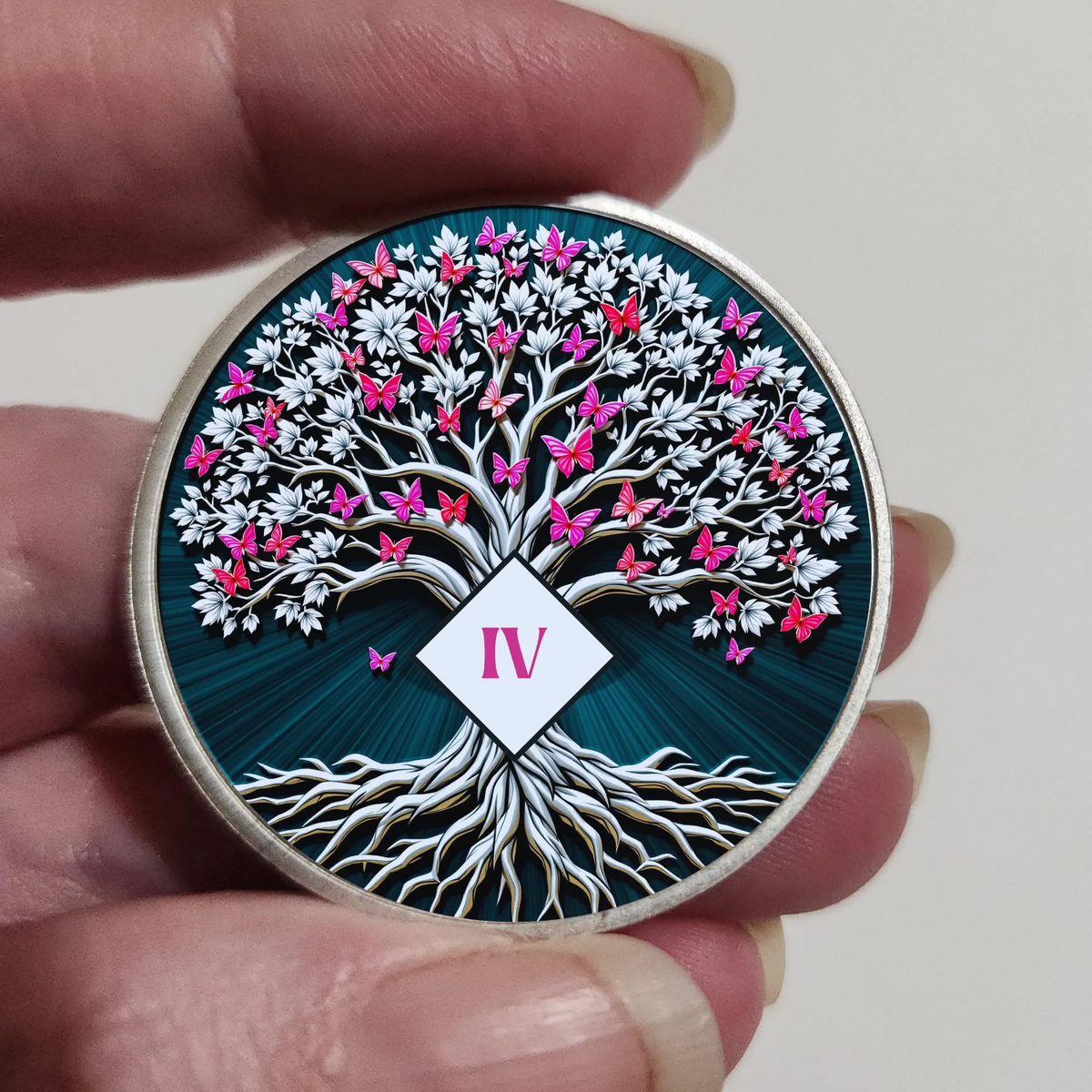 Round dark blue coin held in hand with Tree of Life artwork and IV tag