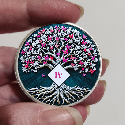 Round dark blue coin held in hand with Tree of Life artwork and IV tag