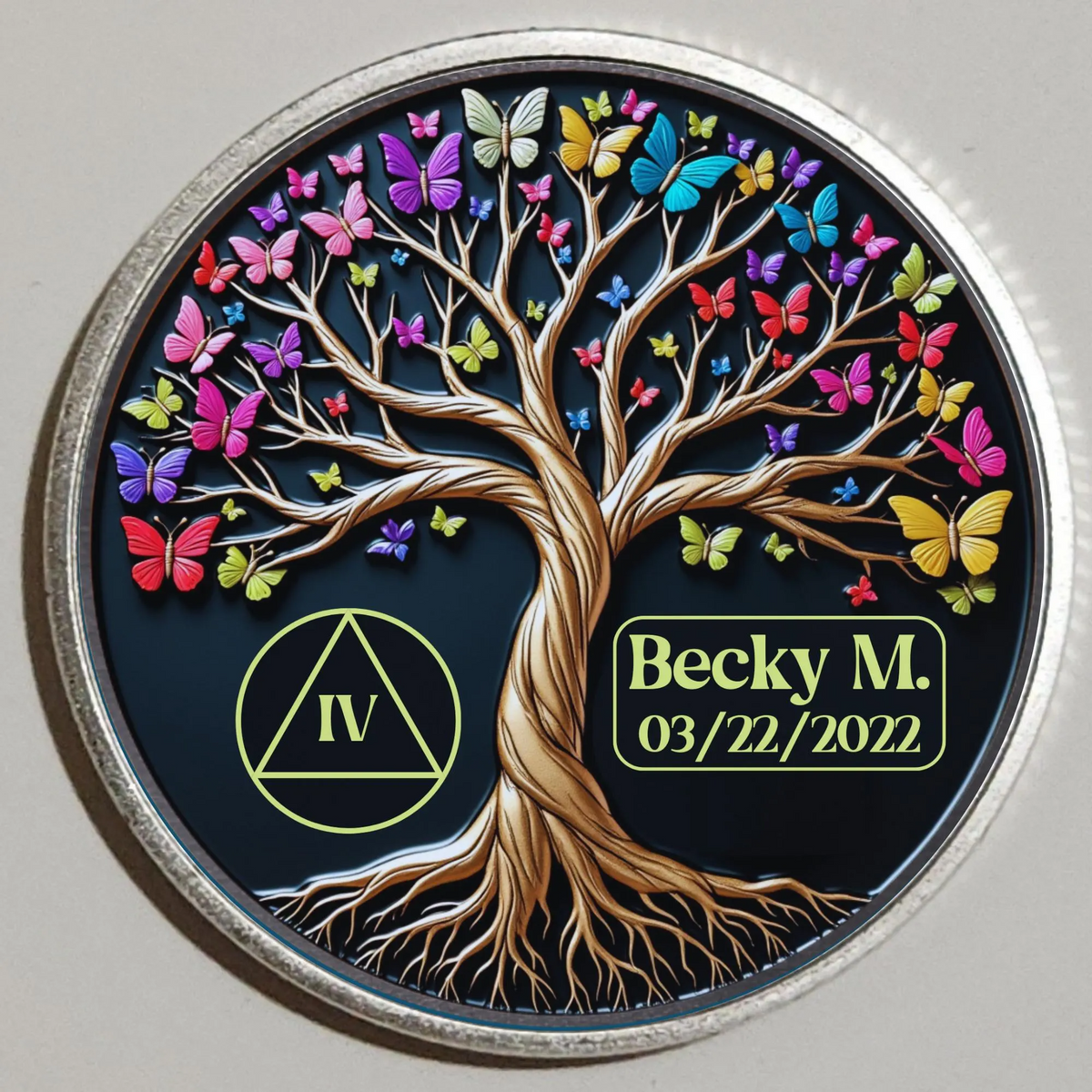 Round coin with colorful tree of life and butterflies; Becky M. 03/22/2022.