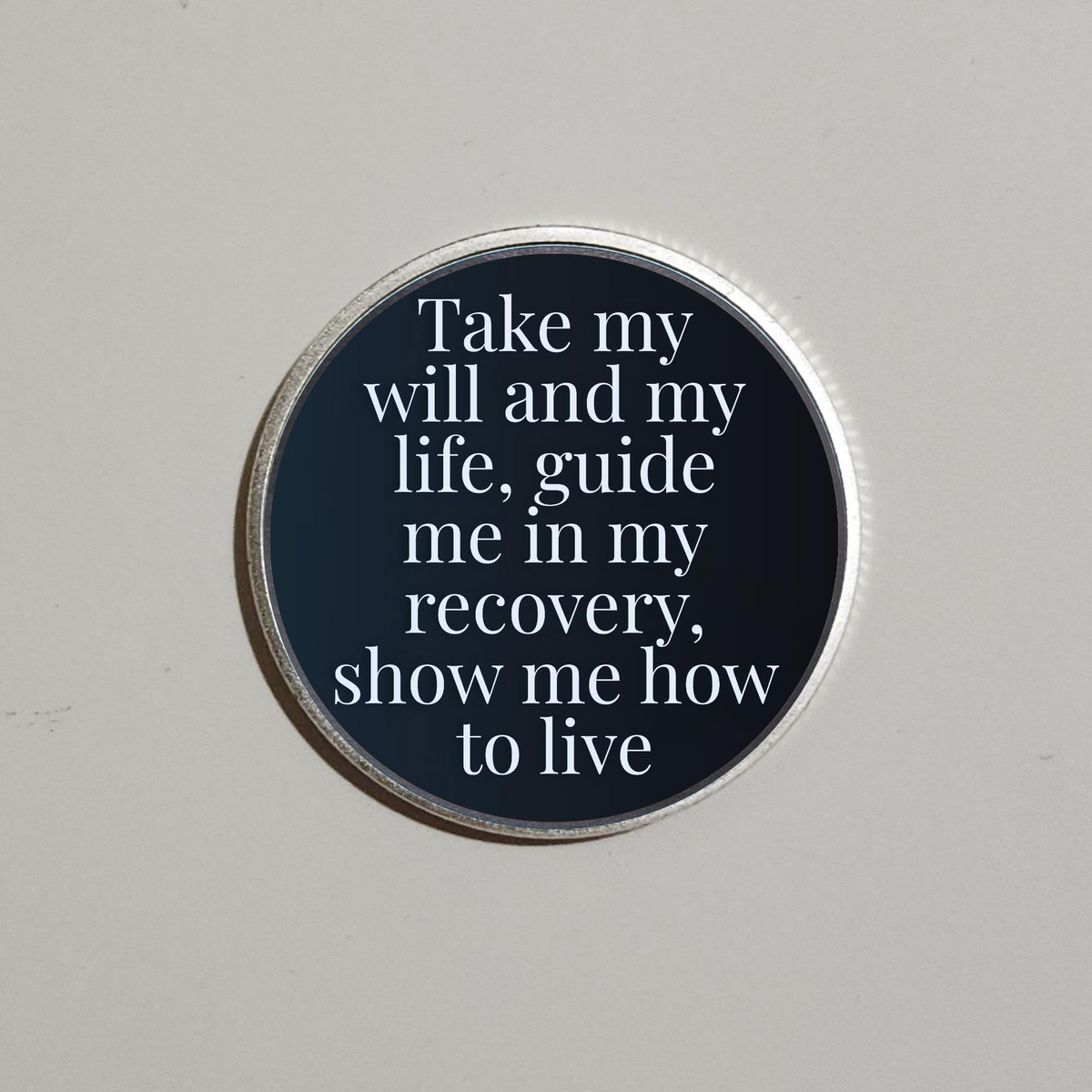 Round dark blue recovery coin with silver rim, text: “Take my will and my life”