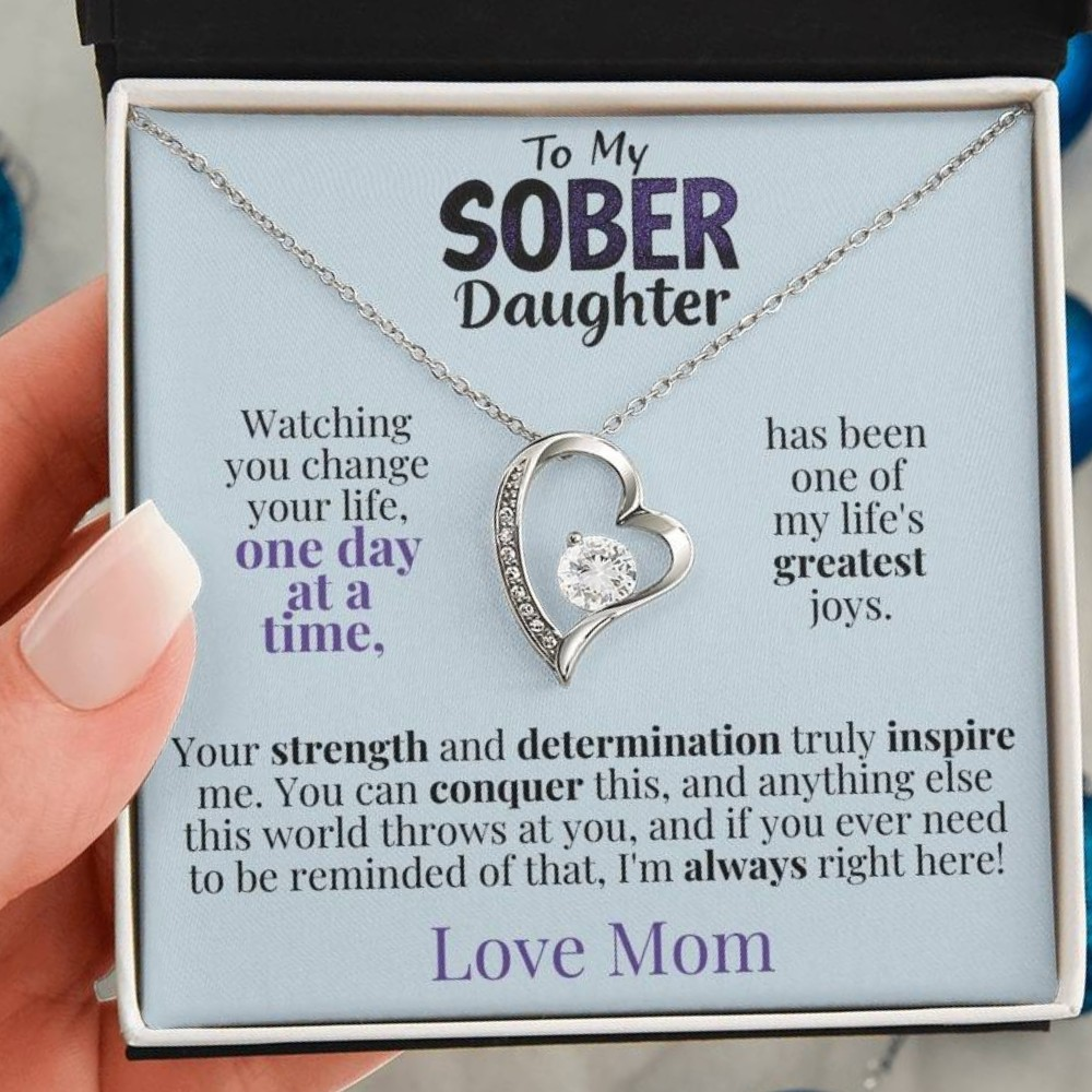 Silver heart pendant necklace on a message card inside an open gift box