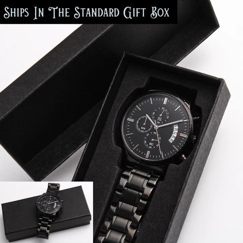 Black chronograph watch in open black presentation box with metal bracelet